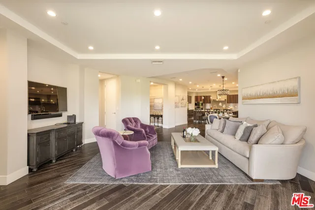 a living room with furniture fireplace and flat screen tv