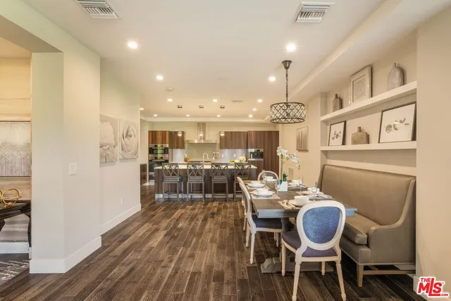 a dining room with furniture and wooden floor