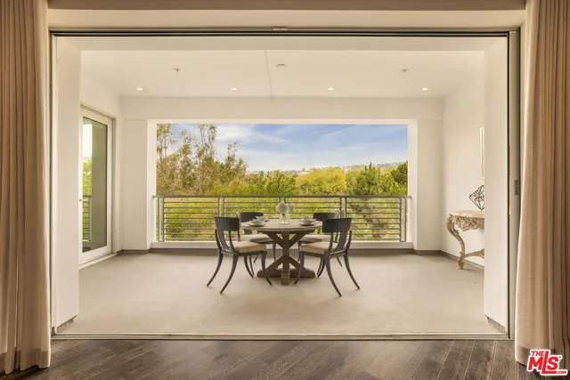 a dining room with furniture and a floor to ceiling window