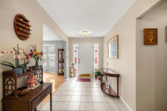 a view of a livingroom with wooden floor and a chandelier