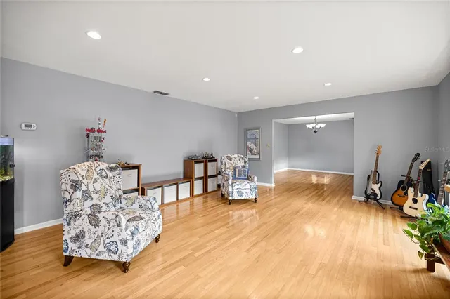 a living room with furniture a flat screen tv and a window