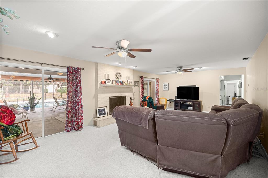 9825 Southwest 202nd Avenue Road Dunnellon, FL 34431 - Photo 20 of 69 a living room with furniture a flat screen tv and a window