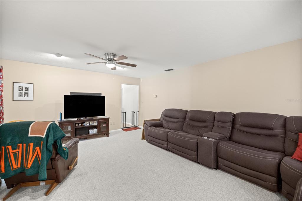9825 Southwest 202nd Avenue Road Dunnellon, FL 34431 - Photo 21 of 69 a living room with furniture and a flat screen tv