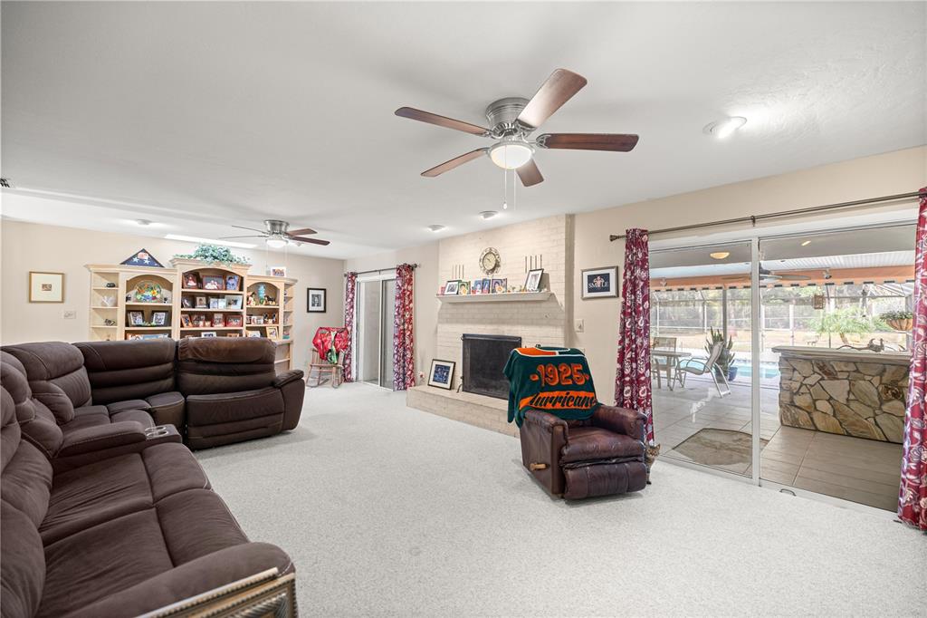 9825 Southwest 202nd Avenue Road Dunnellon, FL 34431 - Photo 22 of 69 a living room with furniture and a fireplace
