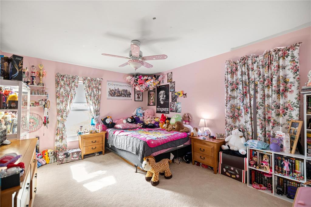 9825 Southwest 202nd Avenue Road Dunnellon, FL 34431 - Photo 33 of 69 a bedroom with a bed and a chandelier