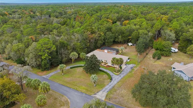 an aerial view of a house with a yard
