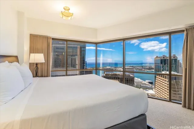 a large bedroom with a large window and a balcony