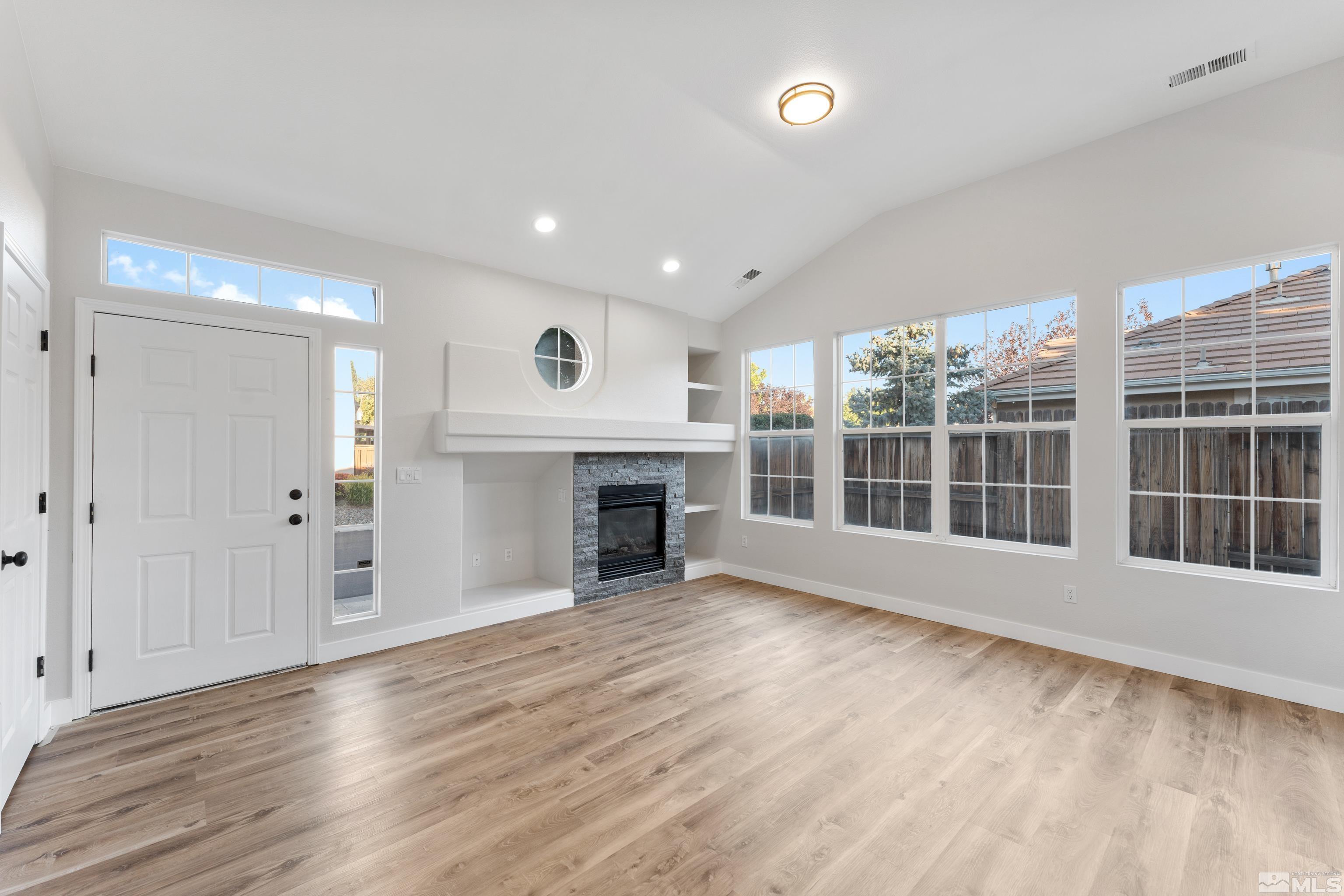 9695 Truckee Meadows Place Reno, NV 89521 - Photo 3 of 38 a view of an empty room with wooden floor and a window