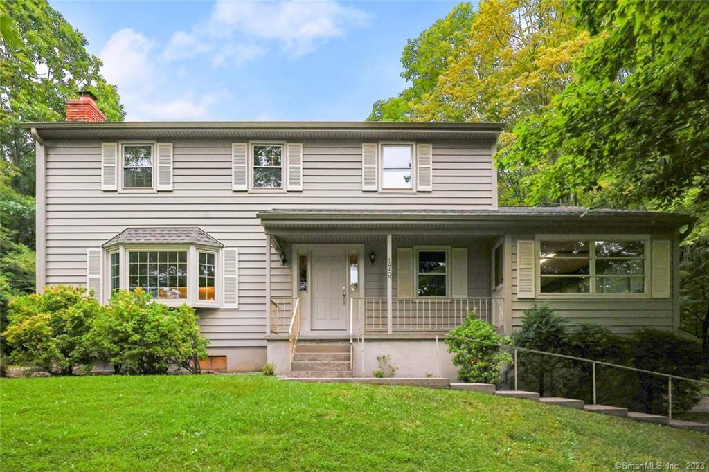 179 Hattertown Road Newtown, CT 06470 - Photo 1 of 1 a front view of a house with a garden and plants