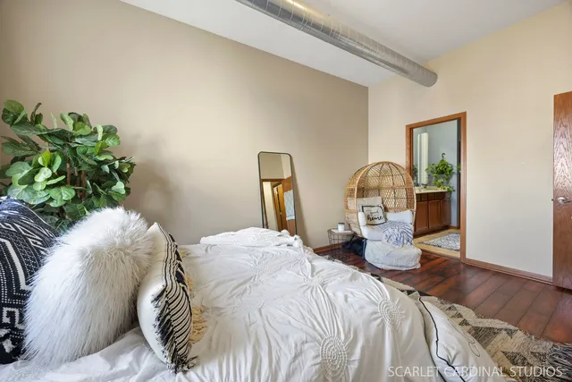 a bedroom with a bed and wooden floor