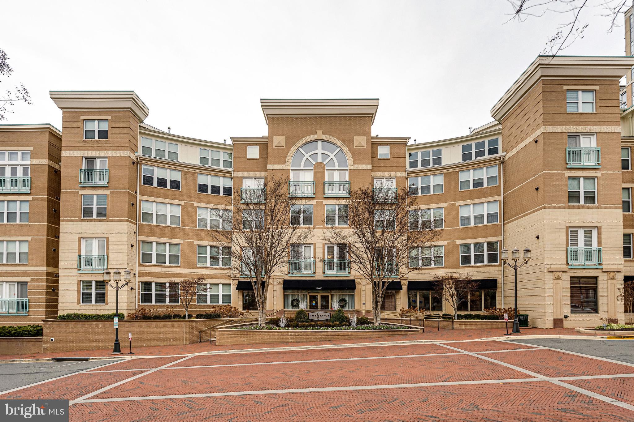 12000 Market Street, Unit 370 Reston, VA 20190 - Photo 1 of 35 a front view of a building with lot of cars and trees