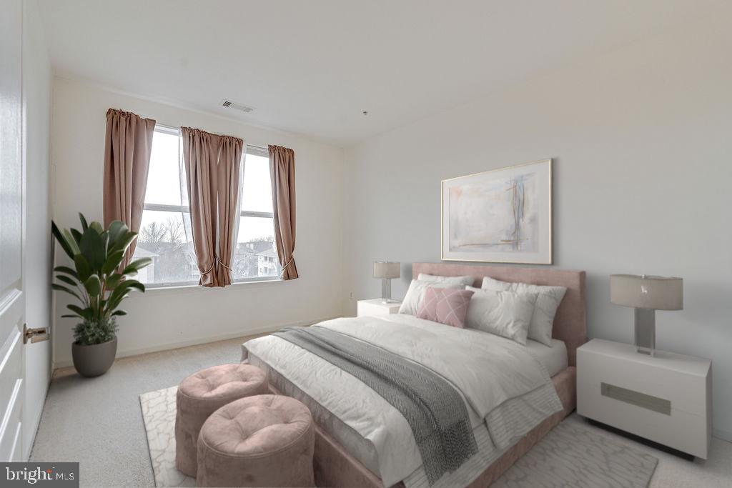 12000 Market Street, Unit 370 Reston, VA 20190 - Photo 15 of 35 a bedroom with a bed and a potted plant