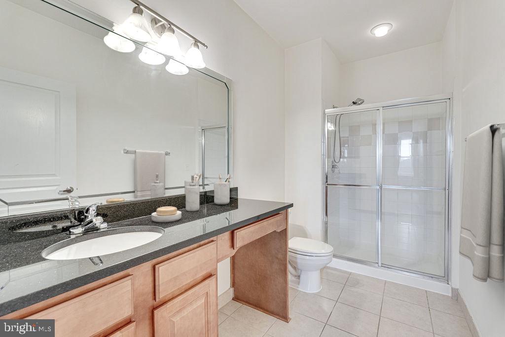 12000 Market Street, Unit 370 Reston, VA 20190 - Photo 18 of 35 a bathroom with a double vanity sink mirror and toilet
