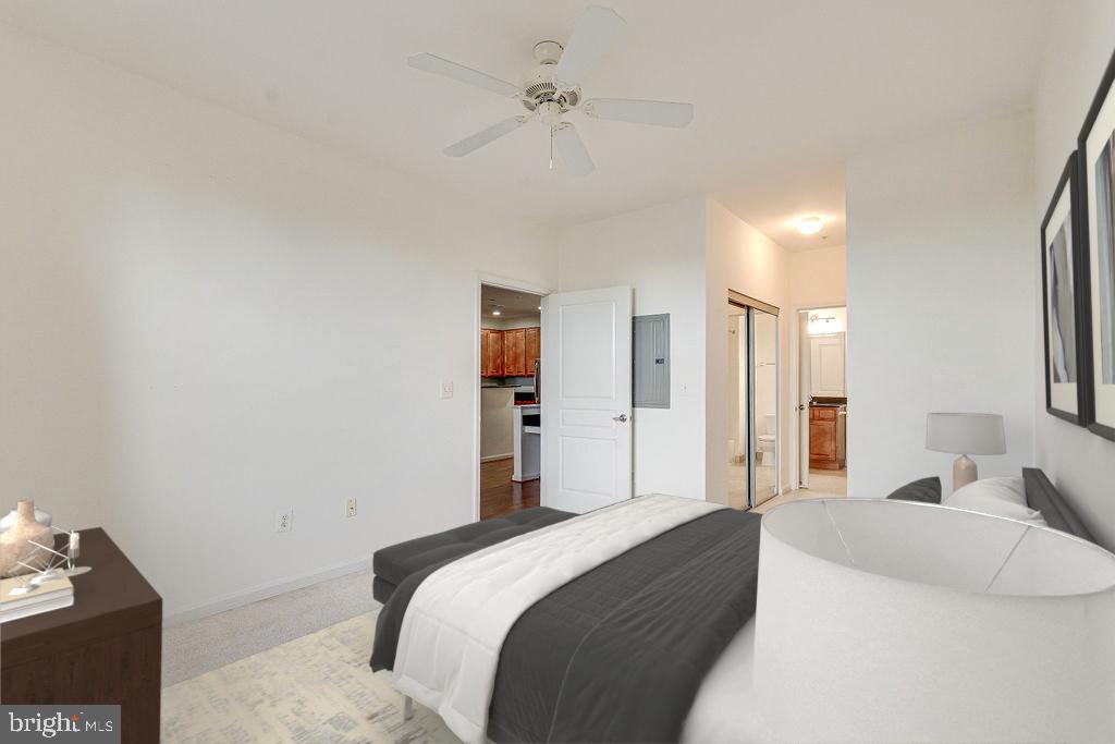 12000 Market Street, Unit 370 Reston, VA 20190 - Photo 22 of 35 a bedroom with a bed and a chandelier