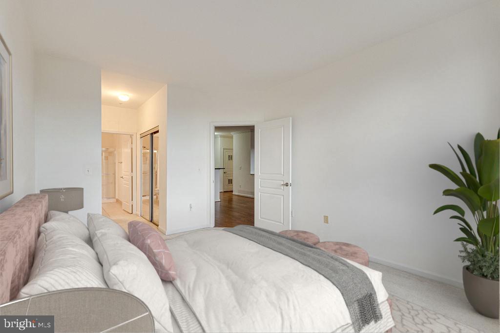 12000 Market Street, Unit 370 Reston, VA 20190 - Photo 20 of 51 a bedroom with a bed and a potted plant