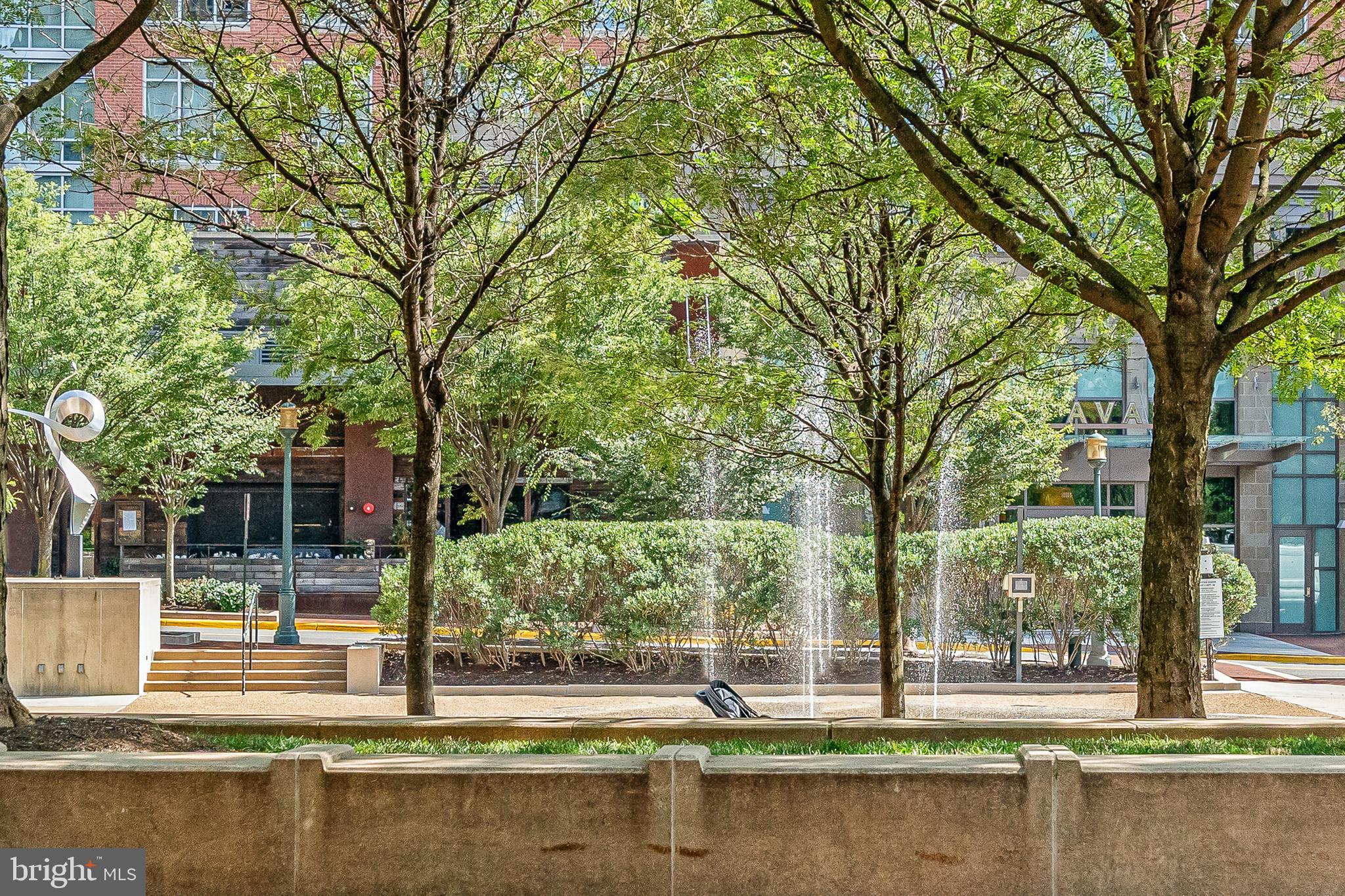 12000 Market Street, Unit 370 Reston, VA 20190 - Photo 36 of 51 a view of a swimming pool and trees in the background