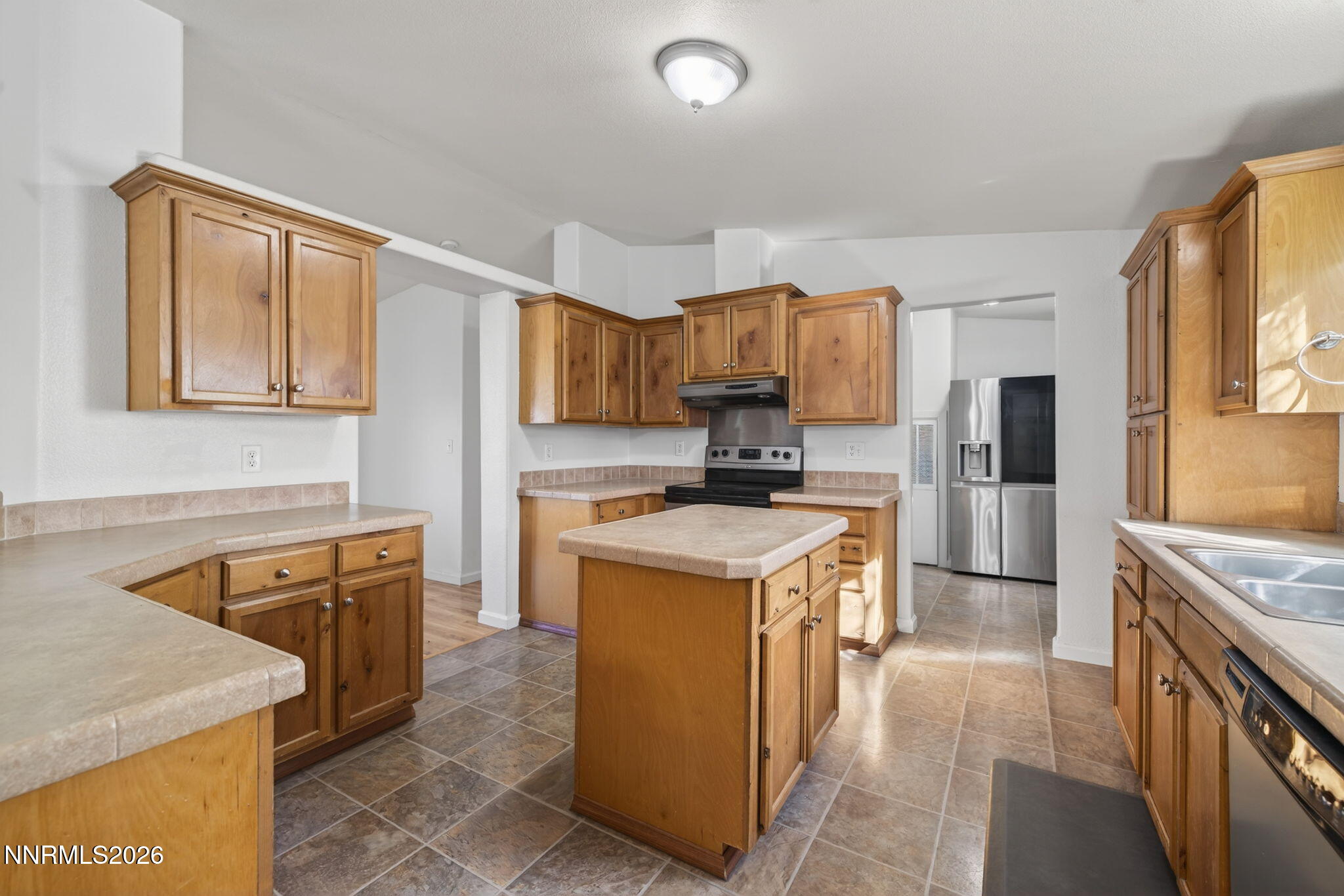 5430 Cox Road Fallon, NV 89406 - Photo 11 of 50 a kitchen with stainless steel appliances granite countertop a stove top oven a sink a refrigerator and white cabinets with wooden floor