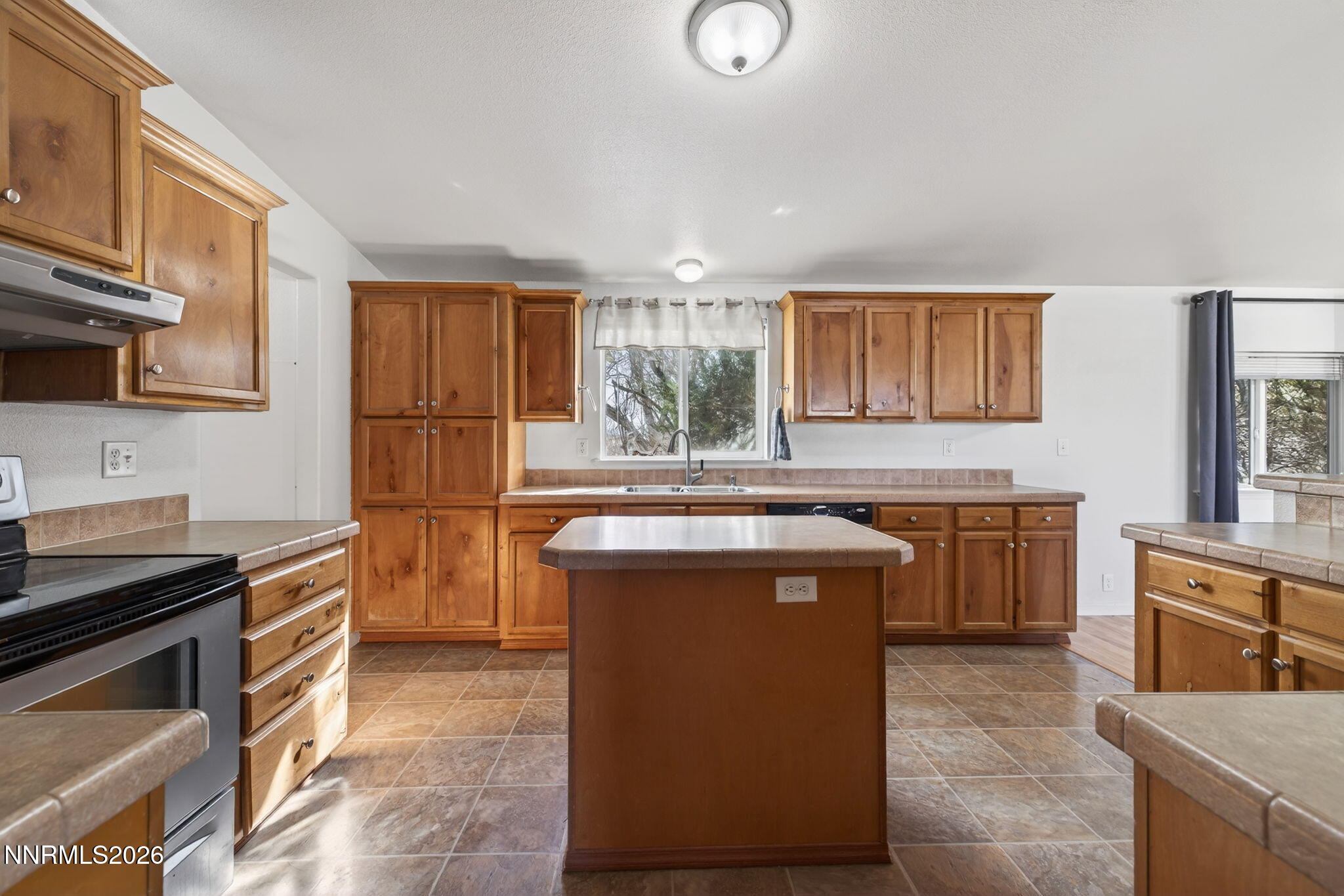 5430 Cox Road Fallon, NV 89406 - Photo 13 of 50 a kitchen with stainless steel appliances granite countertop a stove a sink dishwasher and a refrigerator