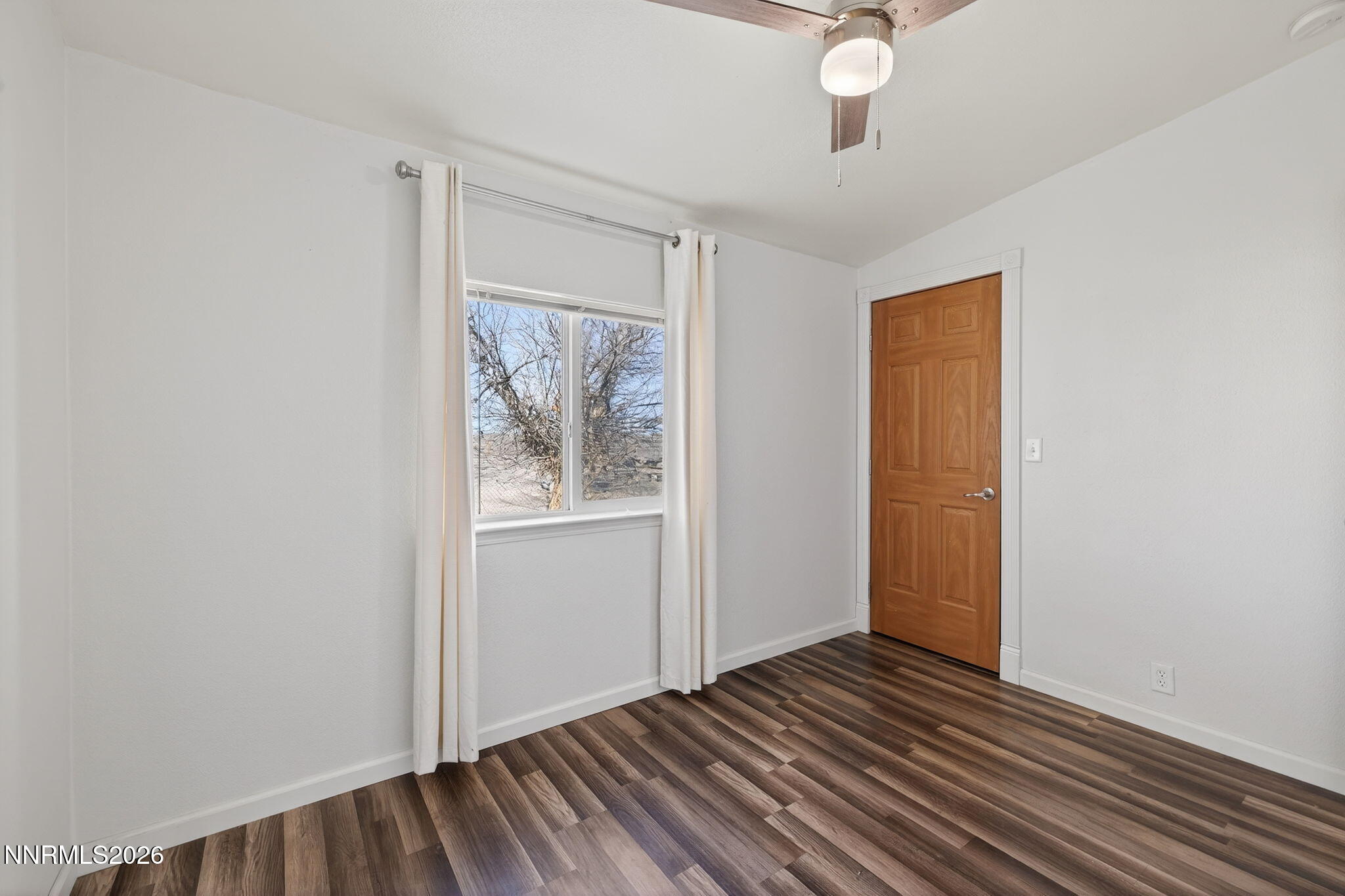 5430 Cox Road Fallon, NV 89406 - Photo 20 of 50 a view of an empty room with wooden floor and a window