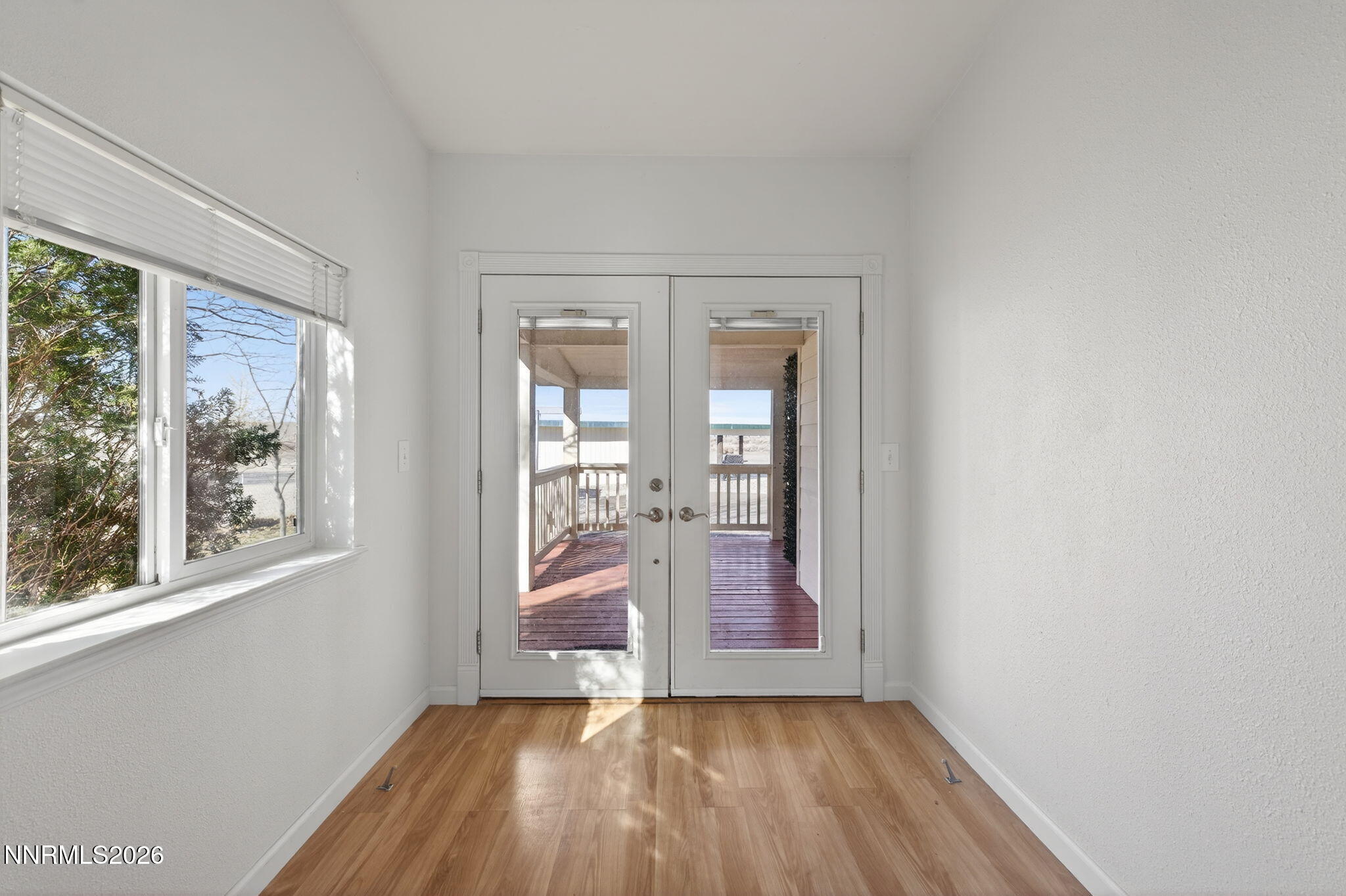 5430 Cox Road Fallon, NV 89406 - Photo 21 of 50 an empty room with wooden floor and windows