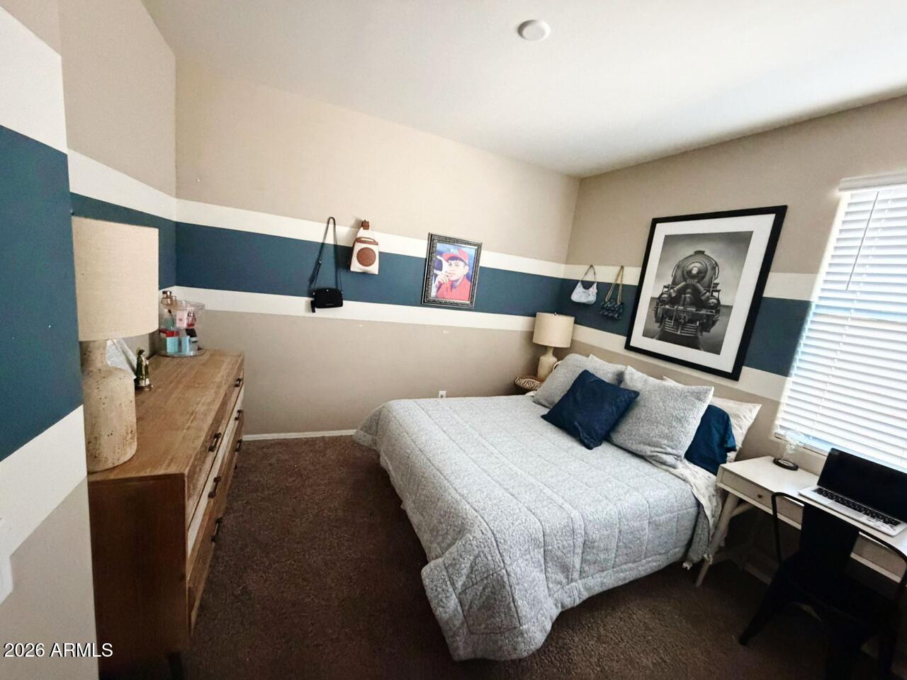 7851 West Riverside Avenue Phoenix, AZ 85043 - Photo 23 of 40 a bedroom with a bed and wooden floor