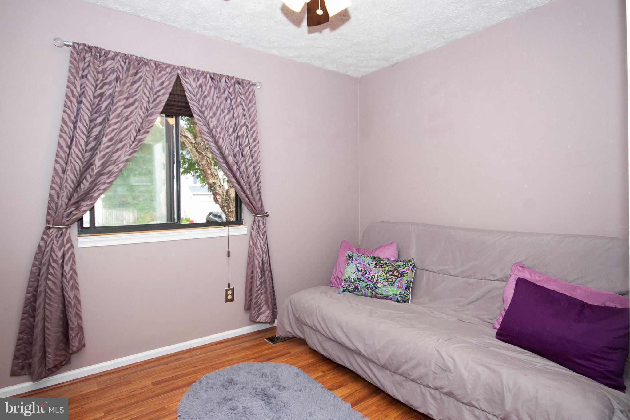 9513 Hallhurst Road Baltimore, MD 21236 - Photo 16 of 30 a bedroom with a bed and a window