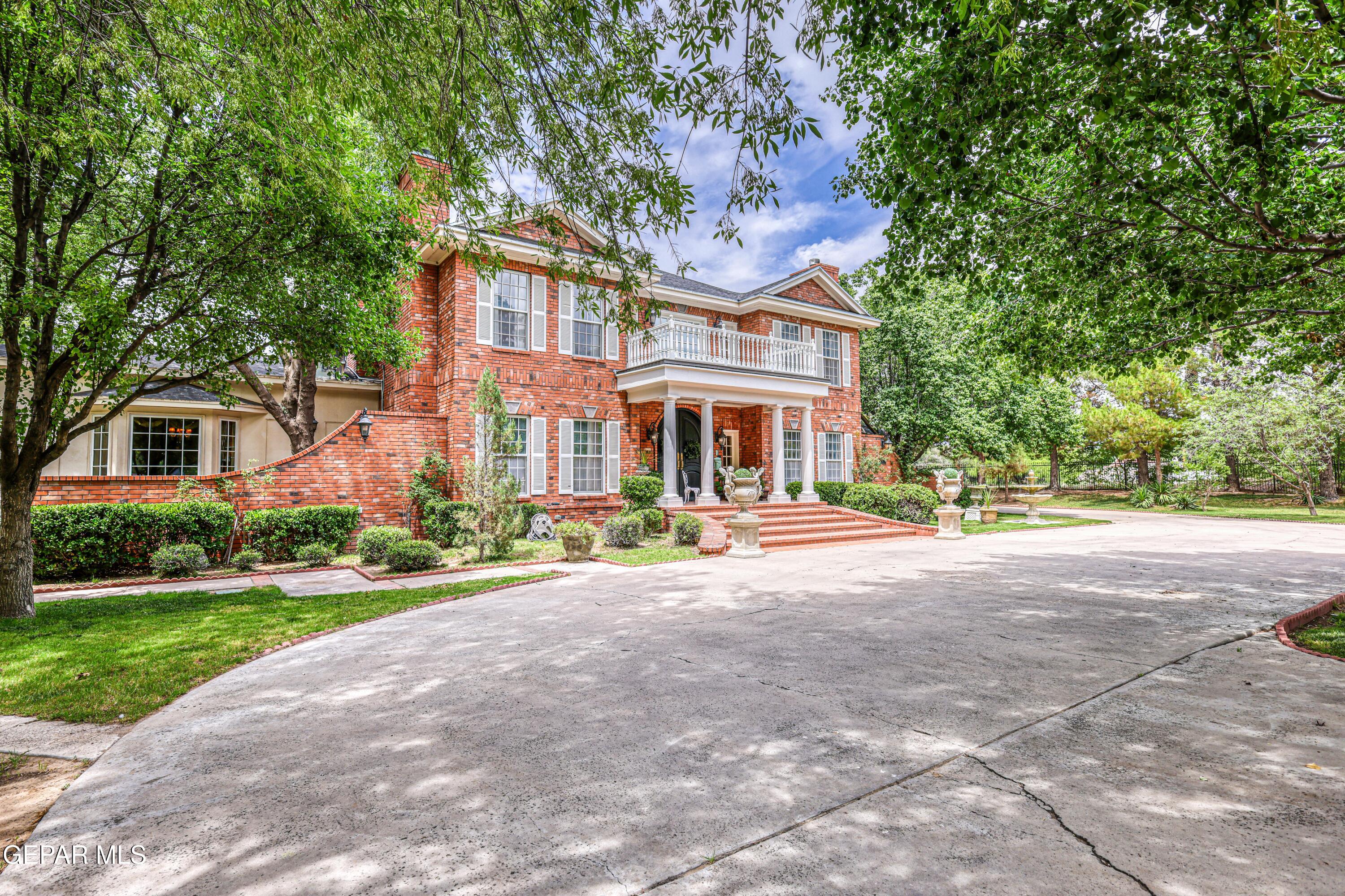 501 Country Club Road El Paso, TX 79932 - Photo 3 of 88 a front view of a house with a yard and potted plants