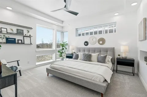 a bedroom with a bed and a large window