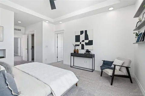 a bedroom with a bed and a chair in it