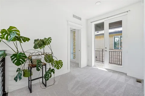 an entryway with table and a potted plant