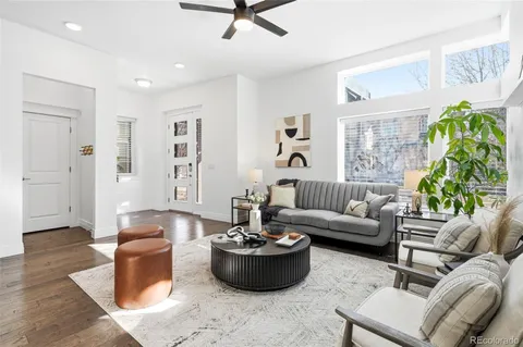a living room with furniture and a potted plant