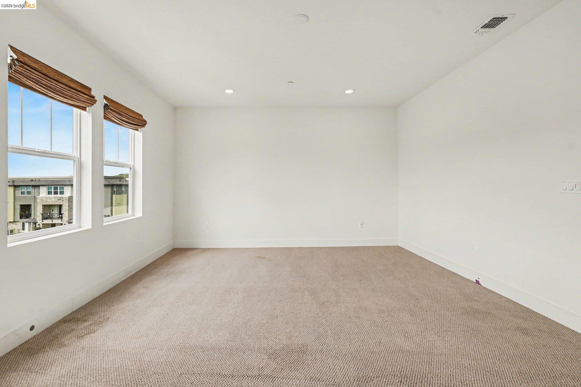 18210 Argento Loop San Ramon, CA 94583 - Photo 22 of 43 Spacious room featuring neutral carpeting, recessed ceiling lighting, and two large windows with horizontal blinds