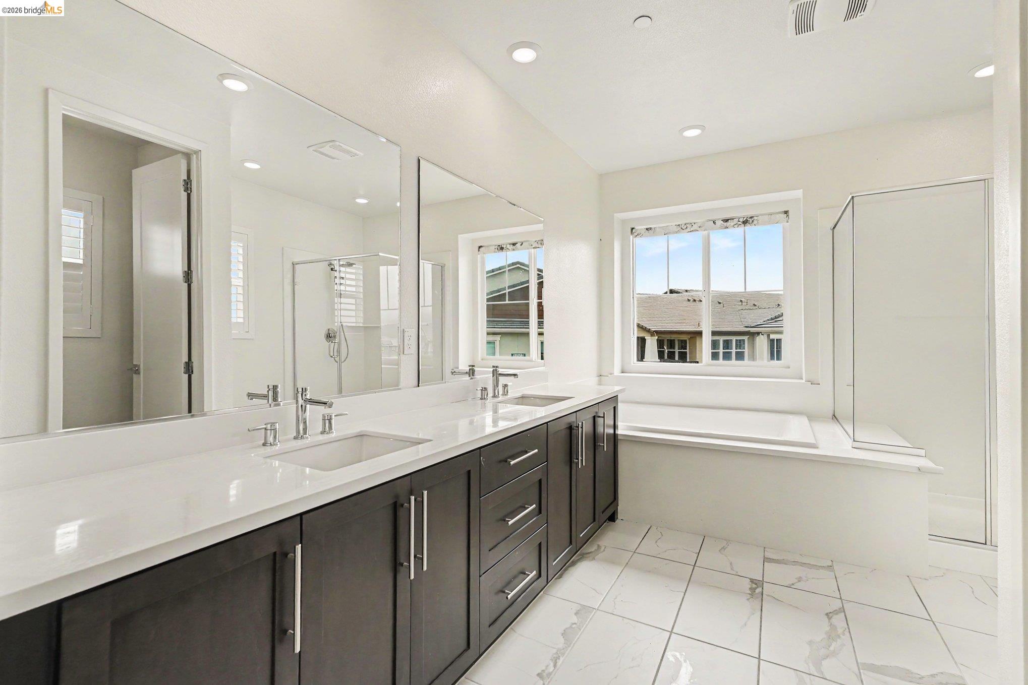 18210 Argento Loop San Ramon, CA 94583 - Photo 24 of 43 Modern bathroom featuring a dual vanity with dark wood cabinetry, white countertops, and undermount sinks