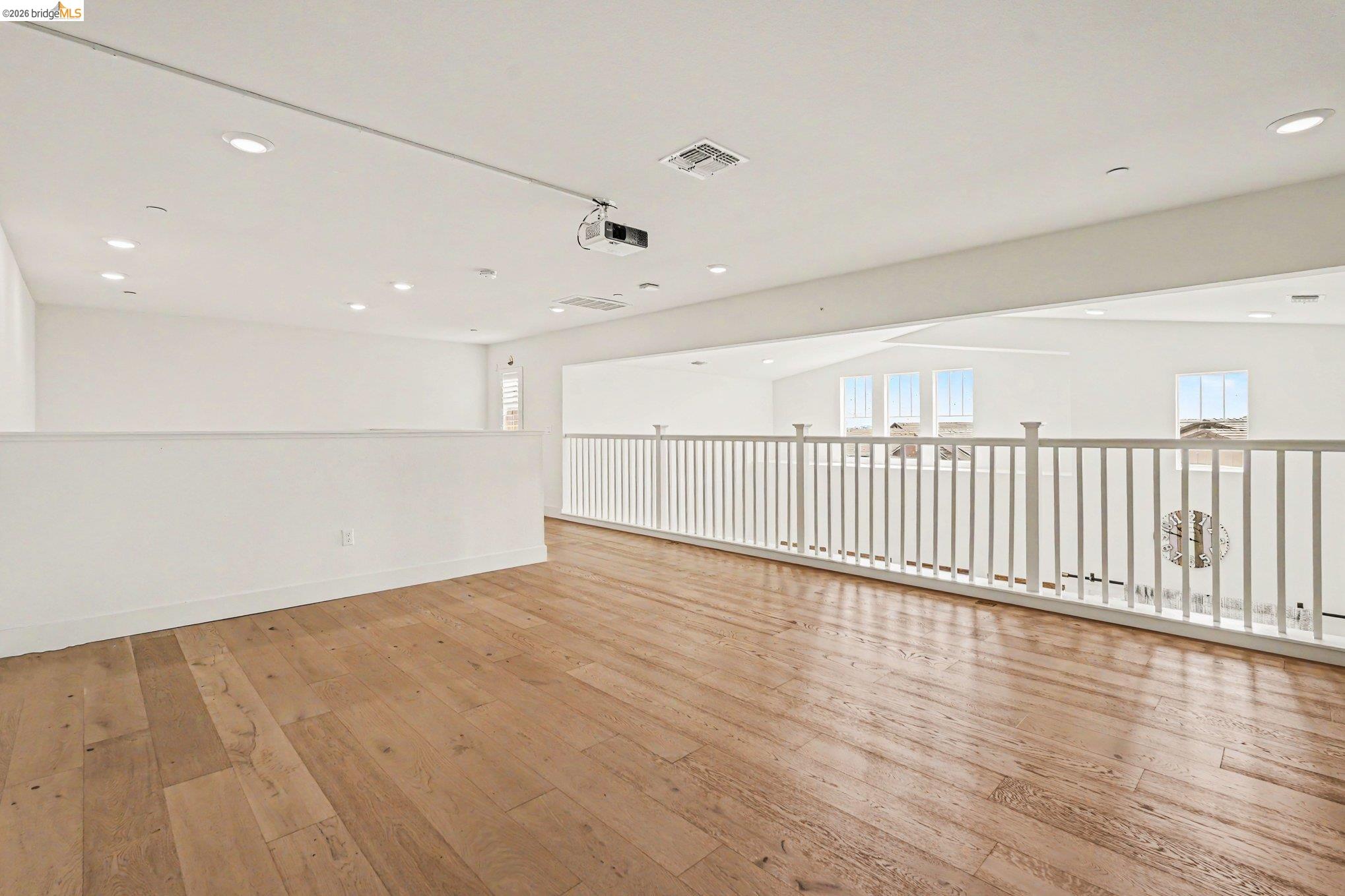 18210 Argento Loop San Ramon, CA 94583 - Photo 28 of 43 Spacious loft featuring wood-finish flooring, recessed lighting, and a built-in projector