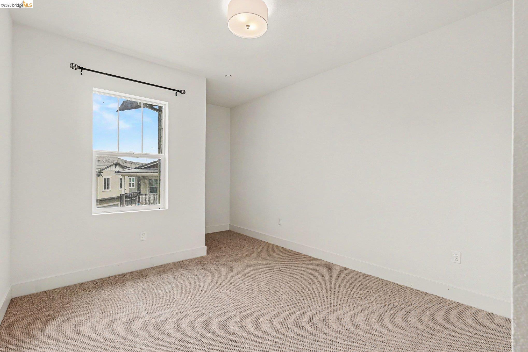 18210 Argento Loop San Ramon, CA 94583 - Photo 30 of 43 Carpeted room featuring a double-hung window, a ceiling-mounted light fixture, white walls, and white baseboards
