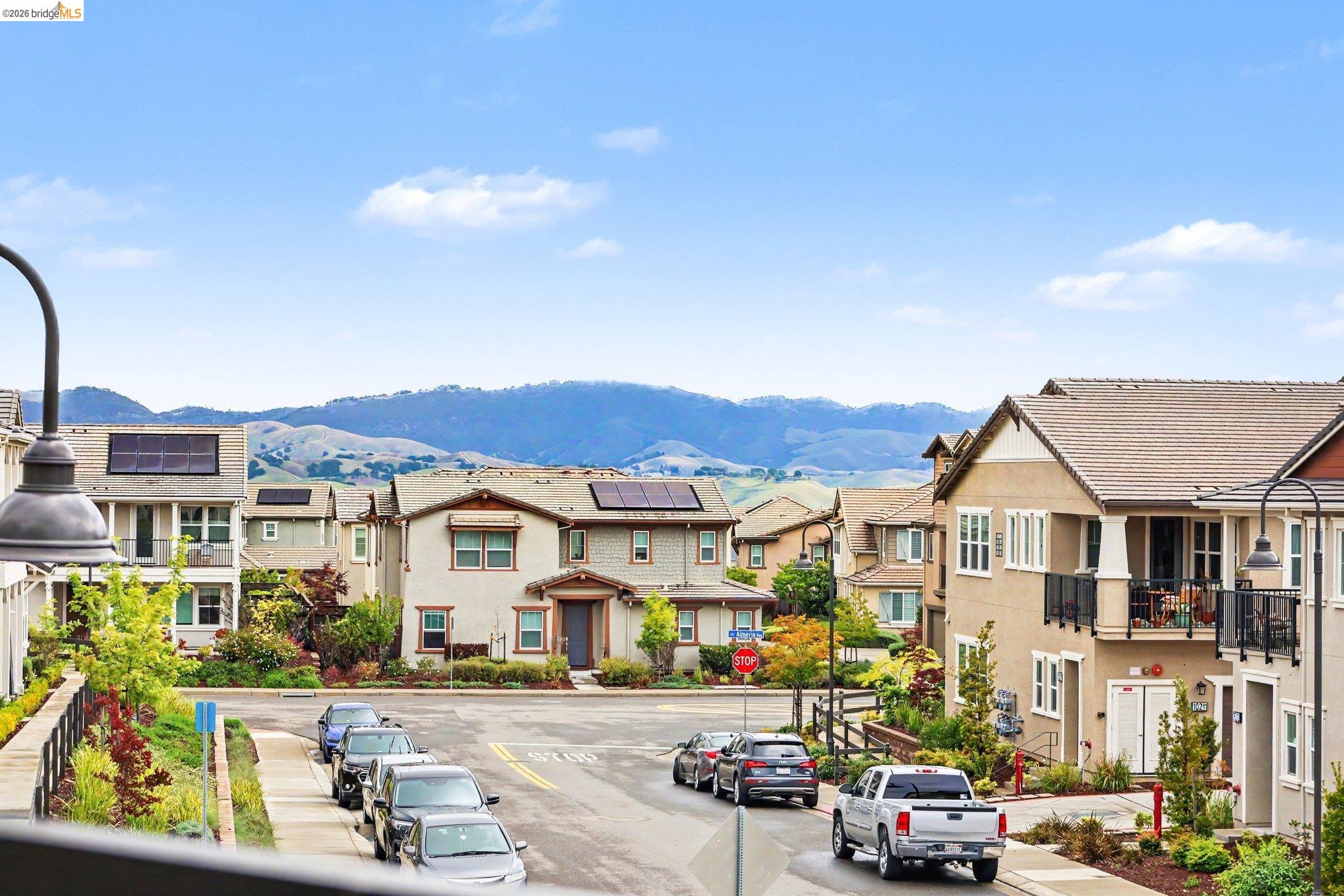 18210 Argento Loop San Ramon, CA 94583 - Photo 32 of 43 Residential streetscape featuring stucco exteriors with varied architectural styles, tile roofing, and integrated solar panels