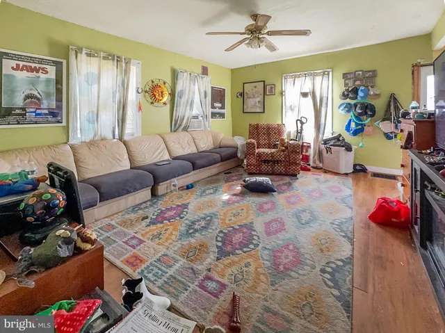 a living room with furniture and painting on the wall