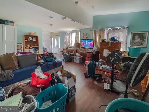 a living room with furniture chess board and a window