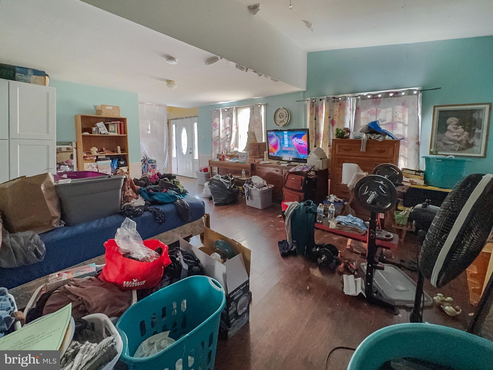 619 Main Street Leesburg, NJ 08327 - Photo 8 of 23 a living room filled with furniture and a flat screen tv