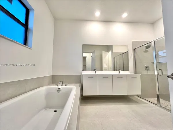a bathroom with a double vanity sink toilet and shower