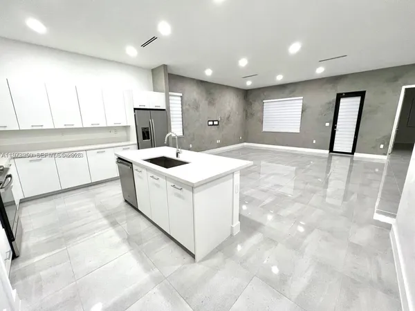a kitchen with a sink stove and cabinets