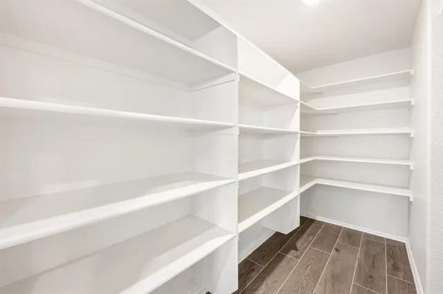 a view of walk in closet with empty racks