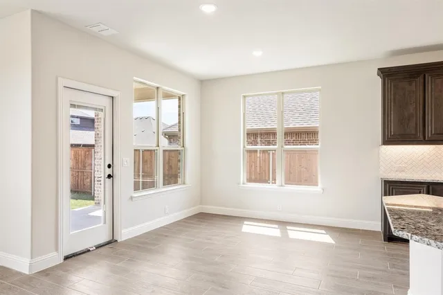 an empty room with windows and closet