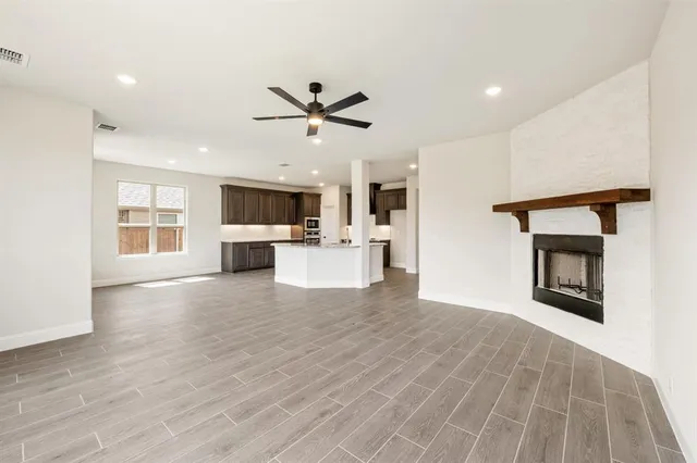 a view of a livingroom with a kitchen and a fireplace