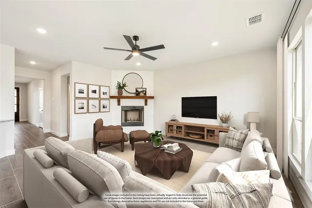 a living room with furniture a flat screen tv and a window