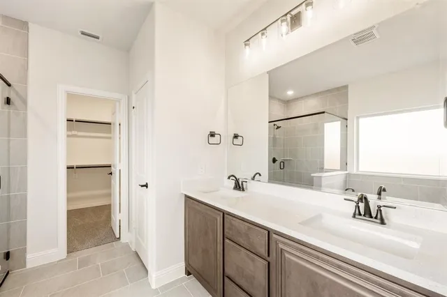a bathroom with a double vanity sink mirror and