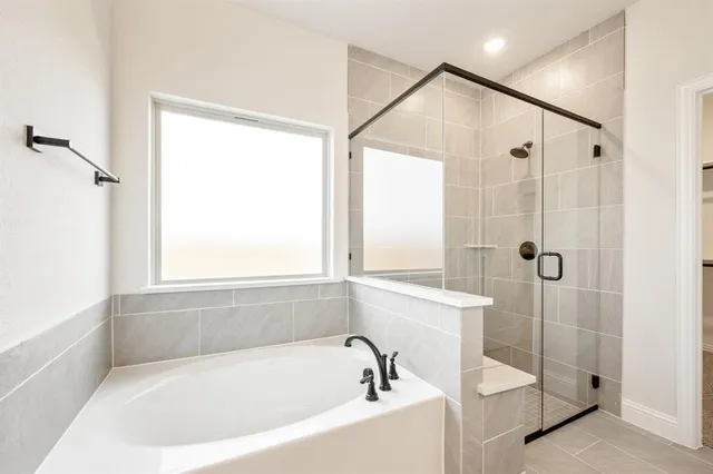 a bathroom with a bathtub and a shower