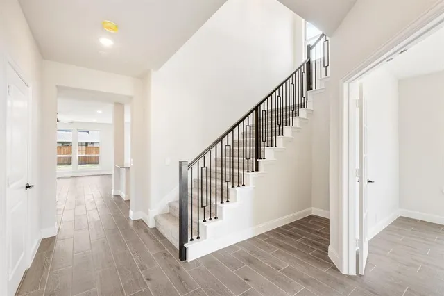 a view of a hallway with wooden floor and entryway