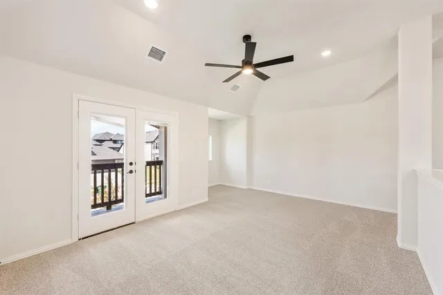 a bedroom with a bed a table and chair