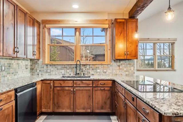 a kitchen with granite countertop a sink and a window